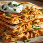 Chicken Quesadilla Recipe with golden crispy tortillas, melted cheese, shredded chicken, and a dollop of sour cream on top — a comforting and flavorful weeknight dinner idea.